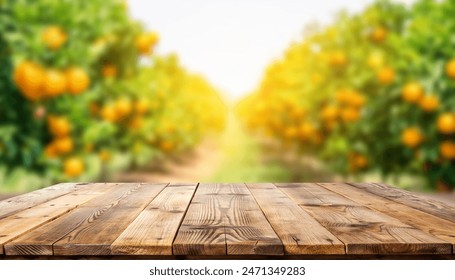 Rustic wooden table top with blurred background of the orange fruit plantation farm in summer sun - Powered by Shutterstock