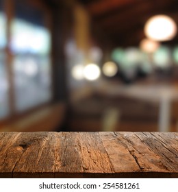 Rustic Wooden Table With A View Of Evening Restaurant Backdrop