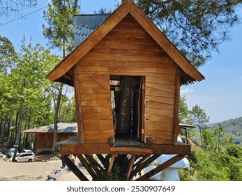 A rustic wooden treehouse perched on sturdy branches, nestled within a lush forest environment, offering a unique and serene retreat. - Powered by Shutterstock