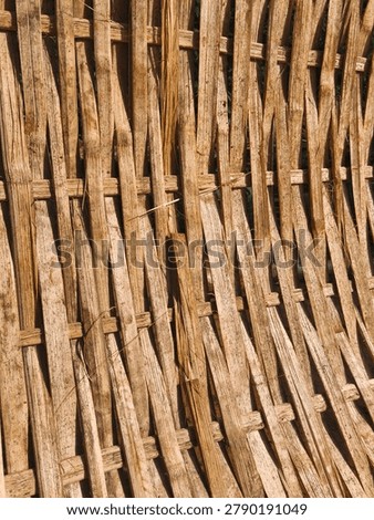 Rustic woven bamboo sheet backdrop. Rough organic wooden texture of traditional handmade wickerwork.