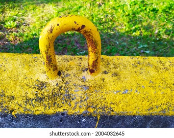 Rustic Yellow Steel Handle On A Roadblock Concrete
