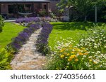 rustical garden - stone paved garden path and flowers - summertime