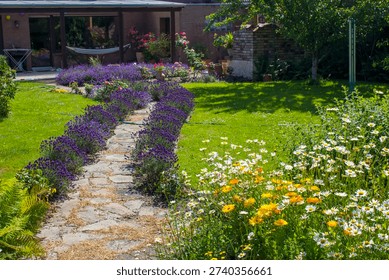rustical garden - stone paved garden path and flowers - summertime