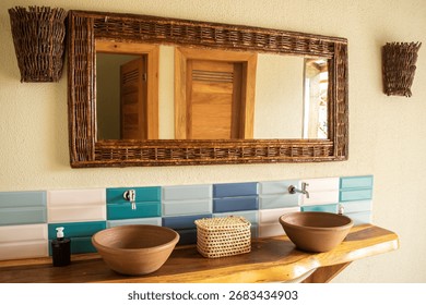 Rustic-chic bathroom vanity featuring dual clay bowl sinks on a natural wood countertop, paired with colorful turquoise and white tile backsplash