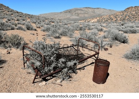 A rusting bedframe being reclaimed by the desert.  Death Valley National Park, California.
