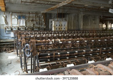 Rusting machinery in abandoned turn of the century silk throwing factory.