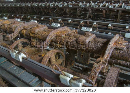 Rusting machinery in abandoned turn of the century silk throwing factory.