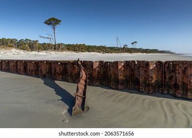 Rusting Metal Sea Wall Beach Erosion Control With Cap Piece Twisted Off From A Storm, Clear Sunny Morning, Horizontal Aspect