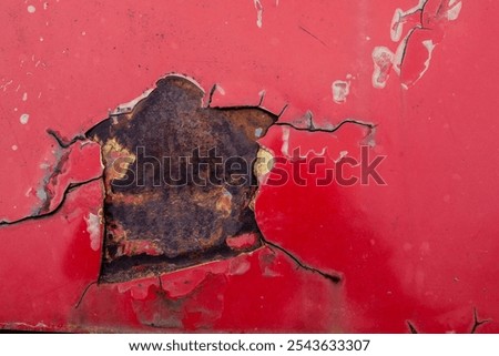 Rusting metal texture with peeling red paint showing decay and wear from exposure over time