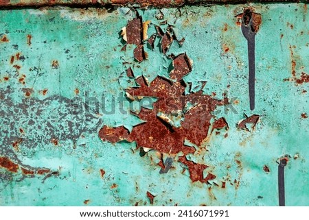 Rusting and pealing paint on a cart.