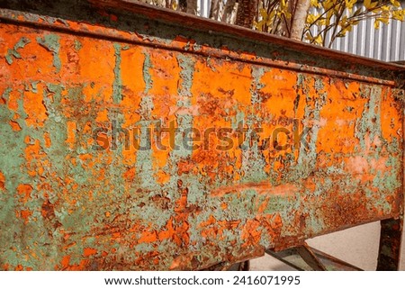 Rusting and pealing paint on a cart.
