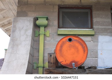 Rusty 50 Gallon Drum Outside Old Building