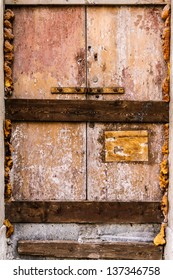 A Rusty, Abandoned And Boarded Up Old Door