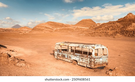 Rusty, abandoned Magic Bus sits in the barren landscape of Cordilliera del Sal, surrounded by dry hills and a clear blue sky, San Pedro de Atacama, Chile. - Powered by Shutterstock