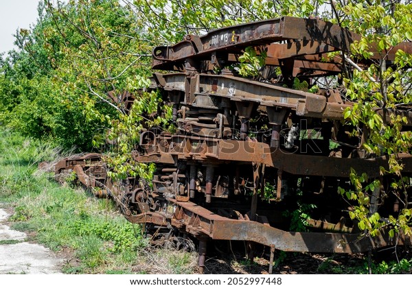 Rusty and abandoned train wheels with\
Railroad in the\
countryside