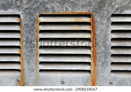 Rusty air vents on a steel textured background