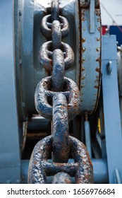 Rusty Anchor Chain On A Winch On A Ship.