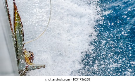 Rusty anchor of the navy ship splashed by sea water while the ship underway