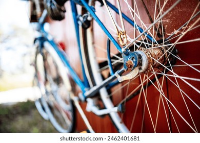 Rusty antique blue bike hanging on a red shed - Powered by Shutterstock