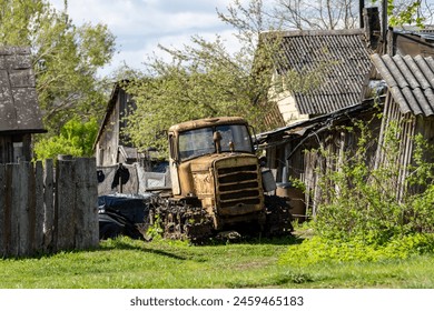 A rusty antique tracked tractor. Non-working condition, rust.  - Powered by Shutterstock