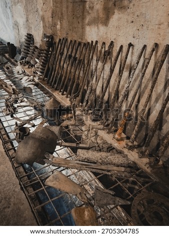Rusty artifacts and military from the Second World War in the dark, concrete corridor of the Riese underground complex in Walim, symbolizing the forgotten stories and secrets of war
