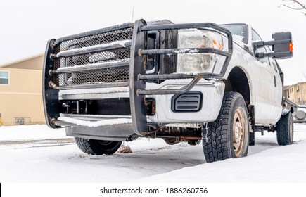 Rusty Black Grille Guard On The Bumper Of White Vehicle Parked On Snowy Road