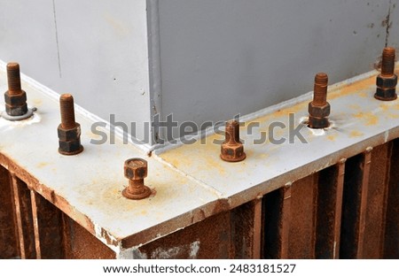 rusty bolt and nut to support base structure of metal post  maintenance of pole structure of large building, hardware for heavy construction industrial