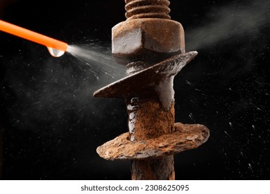 rusty bolt nuts being cleaned with spray