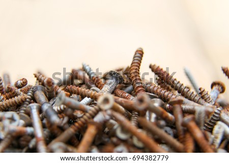 Rusty bolts in the heap, old tools