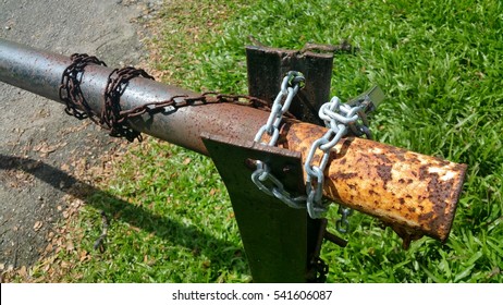 Rusty Boom Gate With Chains