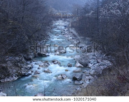 Rusty bridge over the dangerous Rugova river in the Rugova Canyon (Balkans of Kosovo) in a foggy cold day