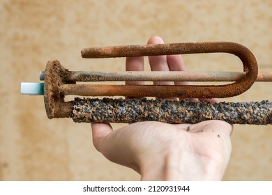 Rusty Broken Water Heater Element In Hand 