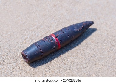rusty bullet lie on sand, military firing background