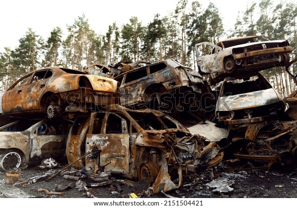 rusty burnt out\
cars destroyed from rocket explosions. fragments of bombs pierced\
cars. Russian vandalism in Ukraine. war in Ukraine. destroyed cars\
in Kyiv, bucha and irpen.