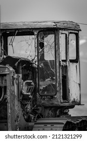 A Rusty Cab Of An Old Bulldozer. The Windows Of The Cabin Are Already Cracked. This Vehicle Has Probably Not Been Moved For A Long Time.