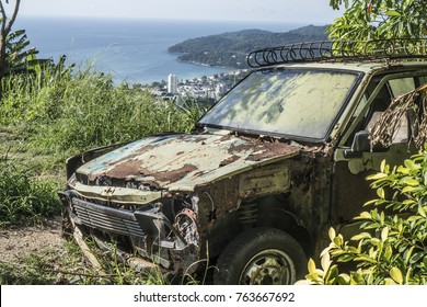 Rusty Car Abandoned On The Hill Isolated Over Beautiful Tropical Island Lanscape Background