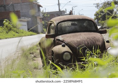 Rusty car abandoned on the street