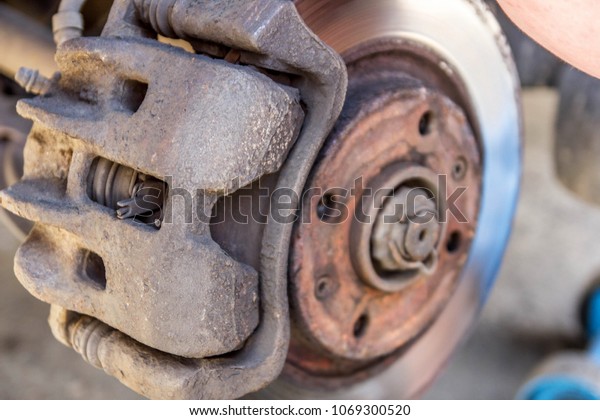 rusty car\
brake disc and caliper. bearing\
repair.