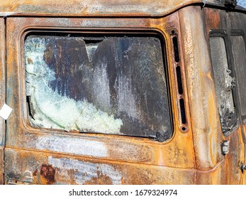 Rusty car with broken windows