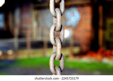 Rusty chain hangs from the ceiling