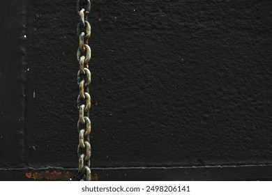 Rusty chains hanging on a black background. - Powered by Shutterstock