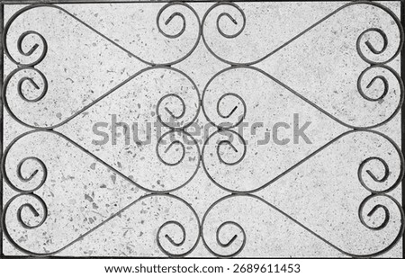 Rusty, curly patterned, wrought gate irons.  Opposites background.