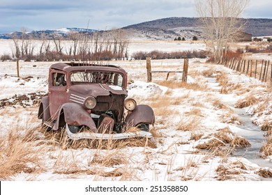 Rusty, dilapidated, abandoned vehicle in a field in rural America on a winter day - Powered by Shutterstock