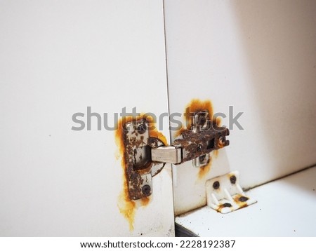 Rusty door hinge. Rust removal product concept.