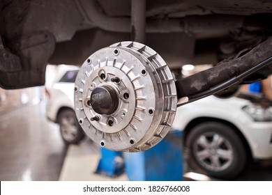 Rusty Drum Brakes, Rear On Car. Change The Old To New Brake Disc On Car In A Garage. Auto Mechanic Repairing