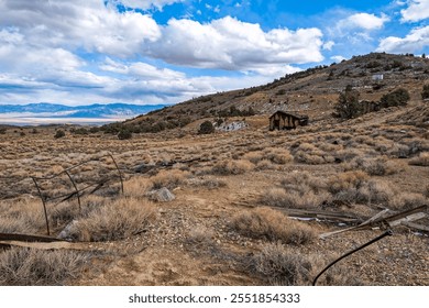 Rusty equipment and abandoned shacks mark the desert hillside of a closed mercury mine, Nevada, USA - Powered by Shutterstock