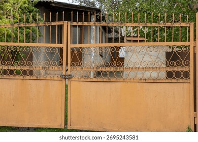 A rusty gate with intricate patterns, showcasing aged beauty and neglect.