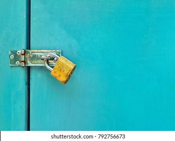 rusty golden lock with locked blue metal door texture background with space