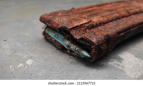 Rusty Gun Magazines On Concrete