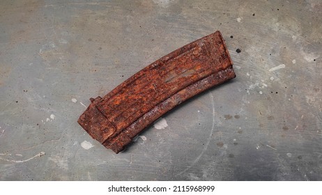 Rusty Gun Magazines On Concrete